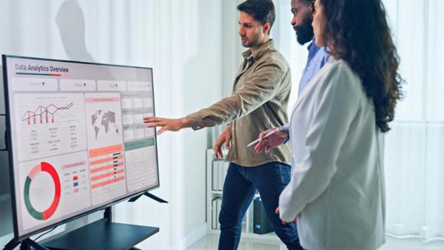 Teammates review data on a large touchscreen