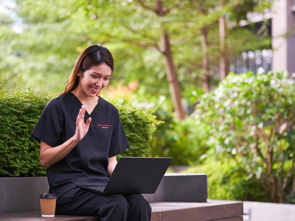 JJ Photo Woman In Scrubs Taking A Meeting Outdoors JJ 1Star