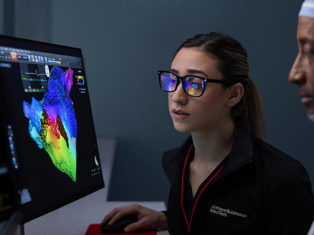 A clinical account specialist supports a physician in the electrophysiology lab.