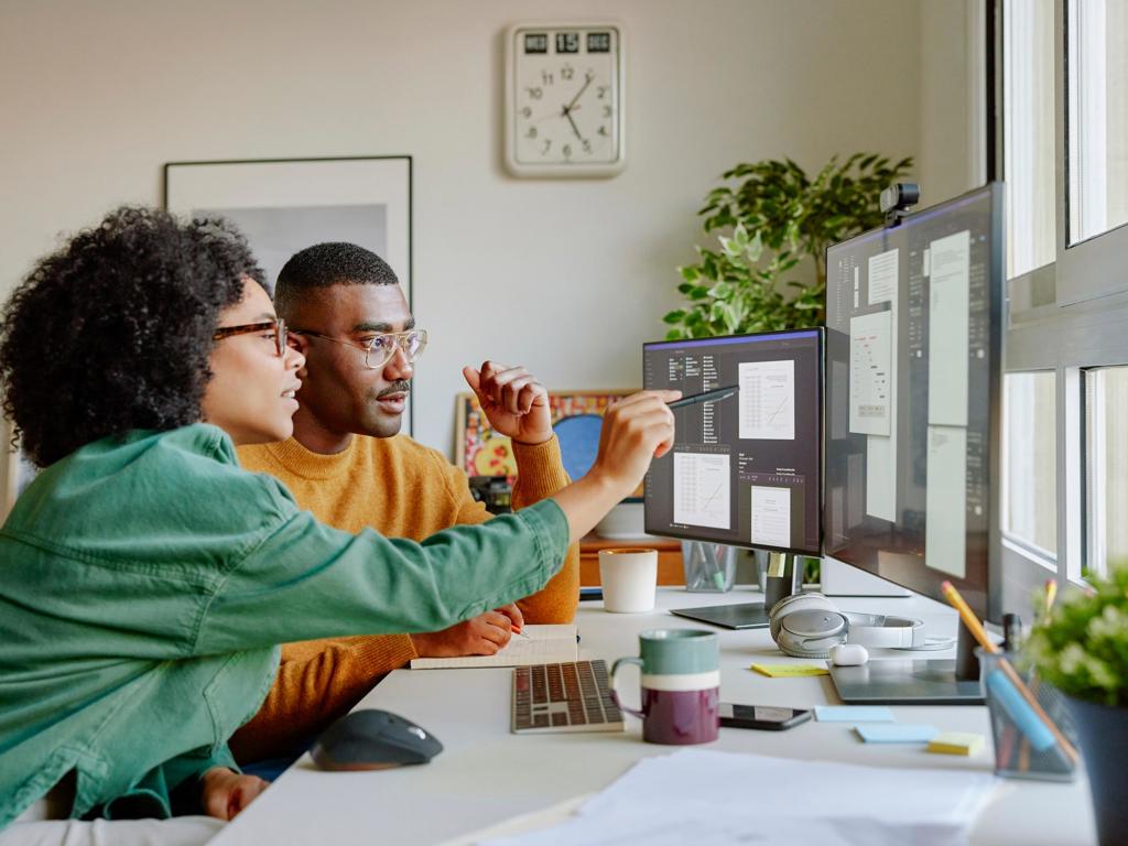 J&J colleagues discuss a project in front of a computer screen