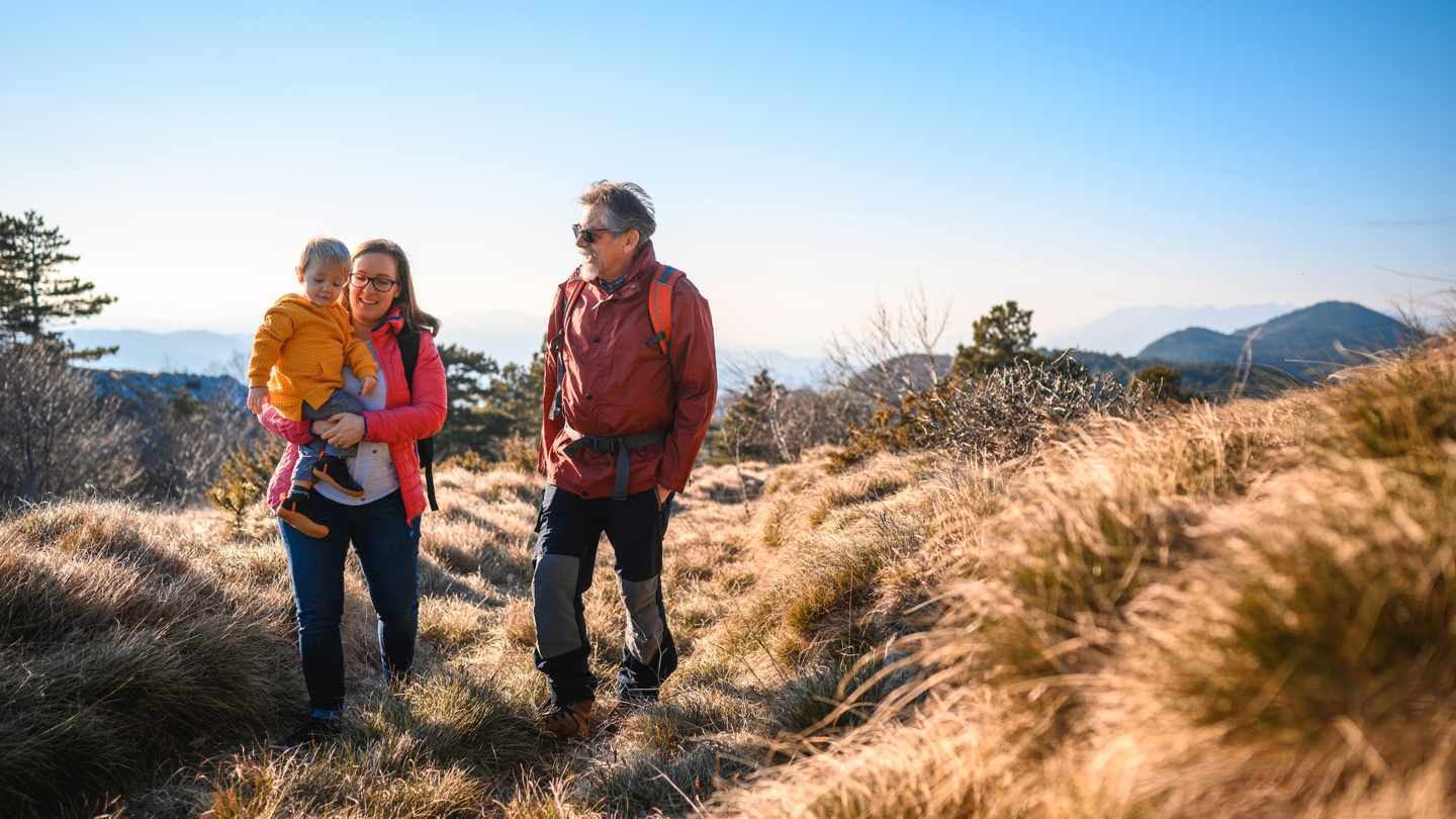 A man, woman and child on an outdoor hike