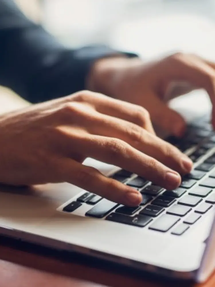 Typing on a laptop