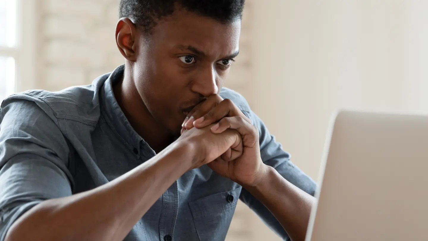 Serious young professional concentrating in front of a computer screen