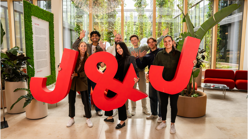 A group of J&J employees in Switzerland holding giant letters spelling J&J