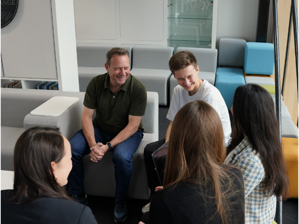 A group of people talking in an office open space