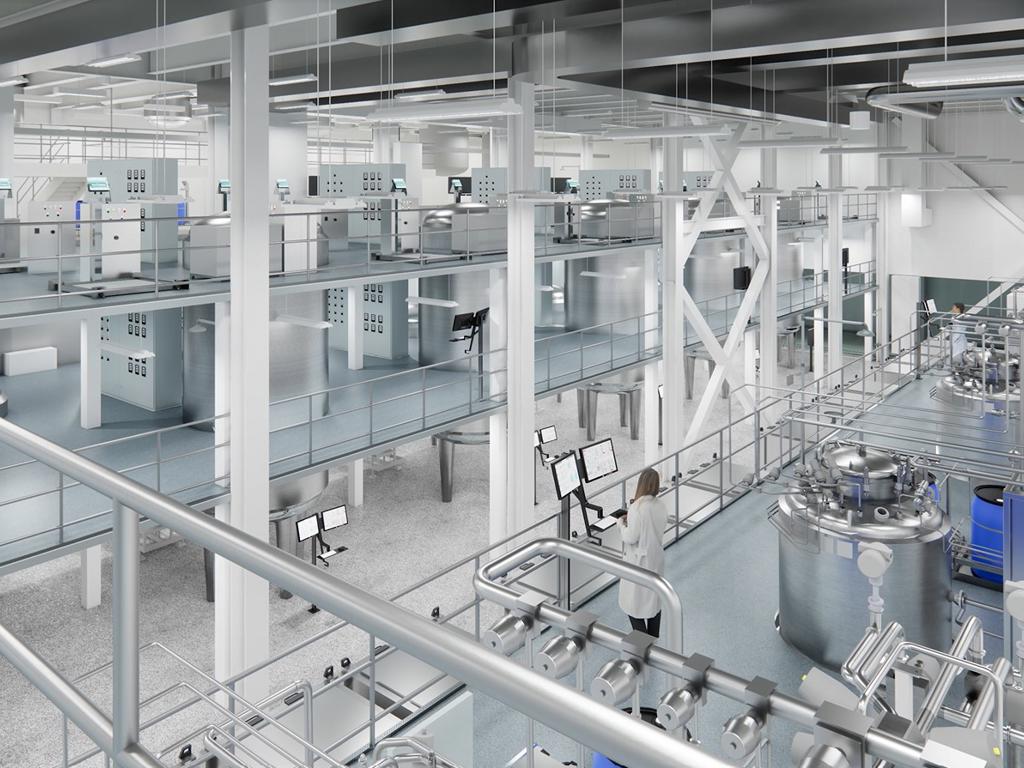 Person standing in front of computers in a large biomedical facility