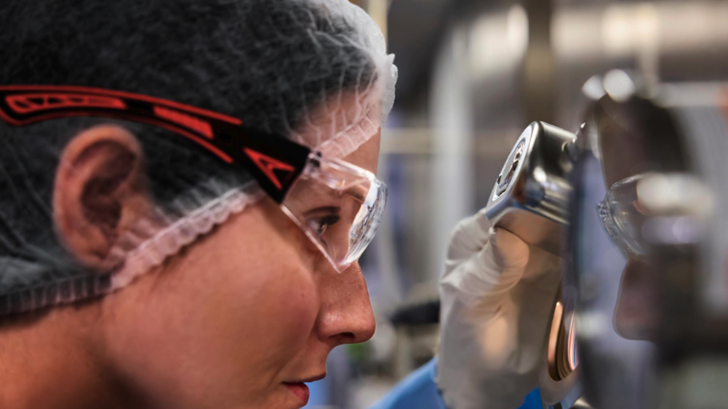 Close-up view of a biologics manufacturing professional wearing safety goggles