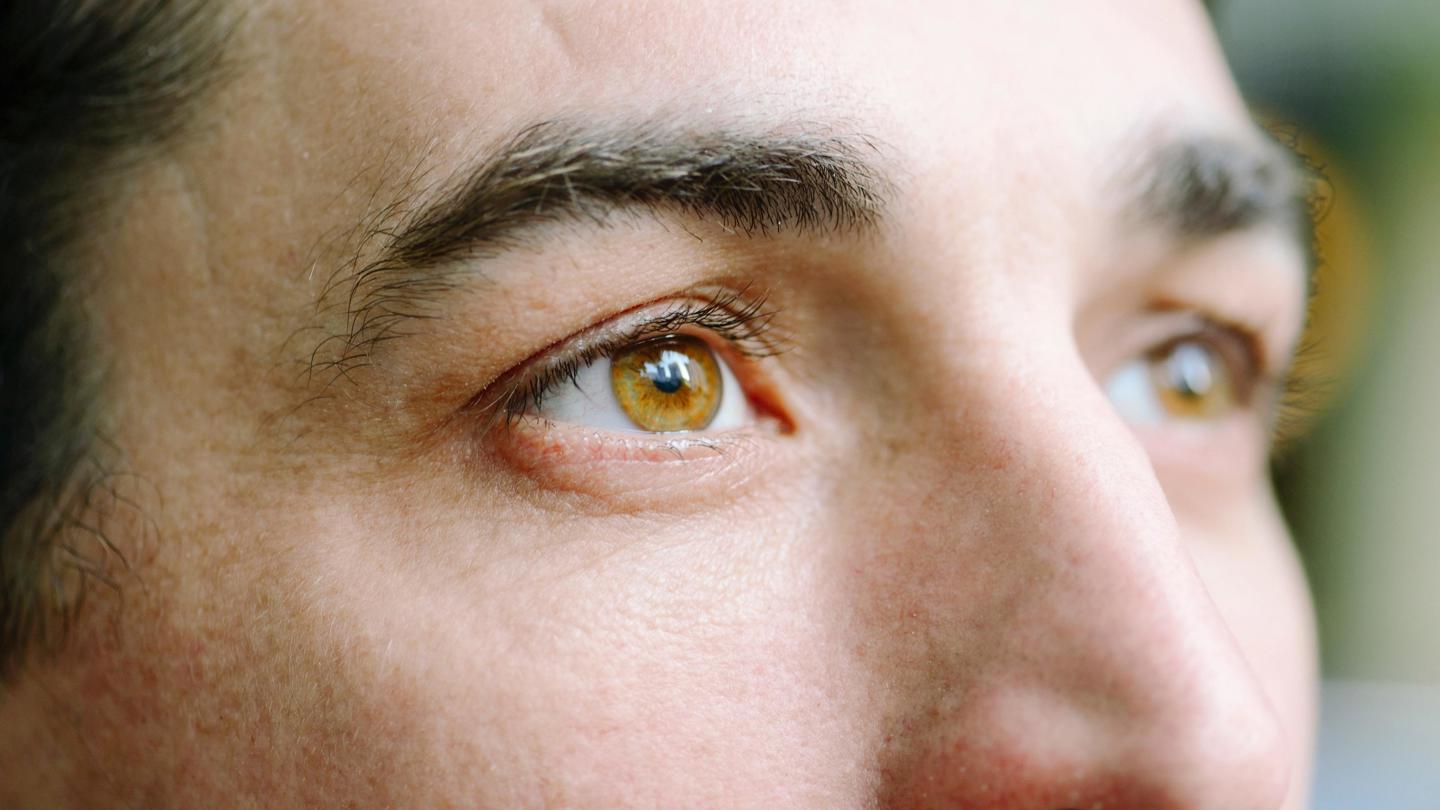 Closeup of a man's eyes looking away from the camera.